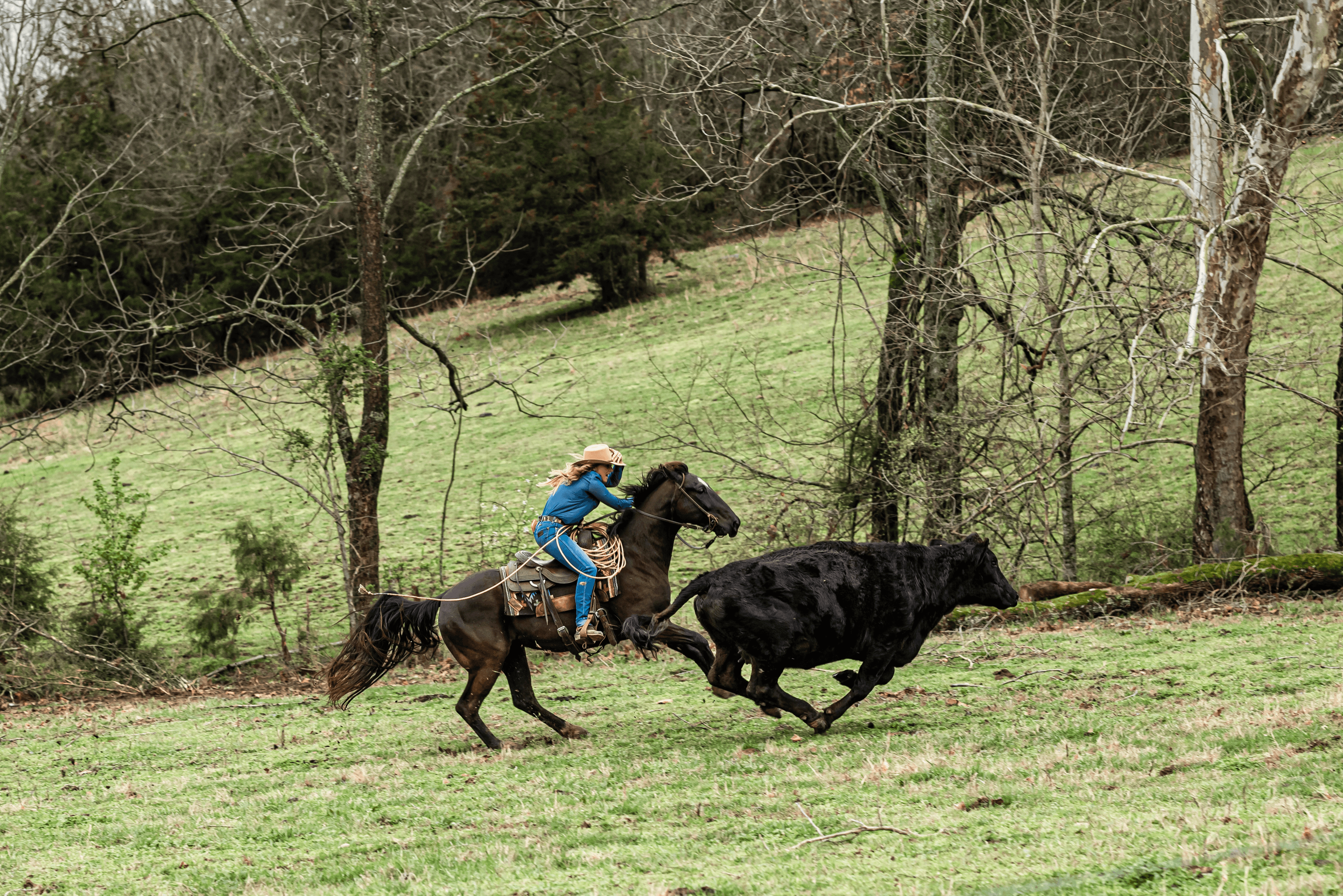 Cowgirl on horseback in Western landscape